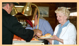 patron receiving food at the dinner buffet
